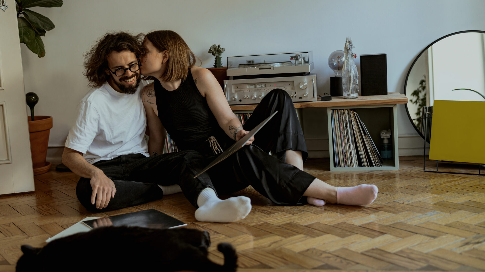 Two people sitting together listening to a record on a quiet evening