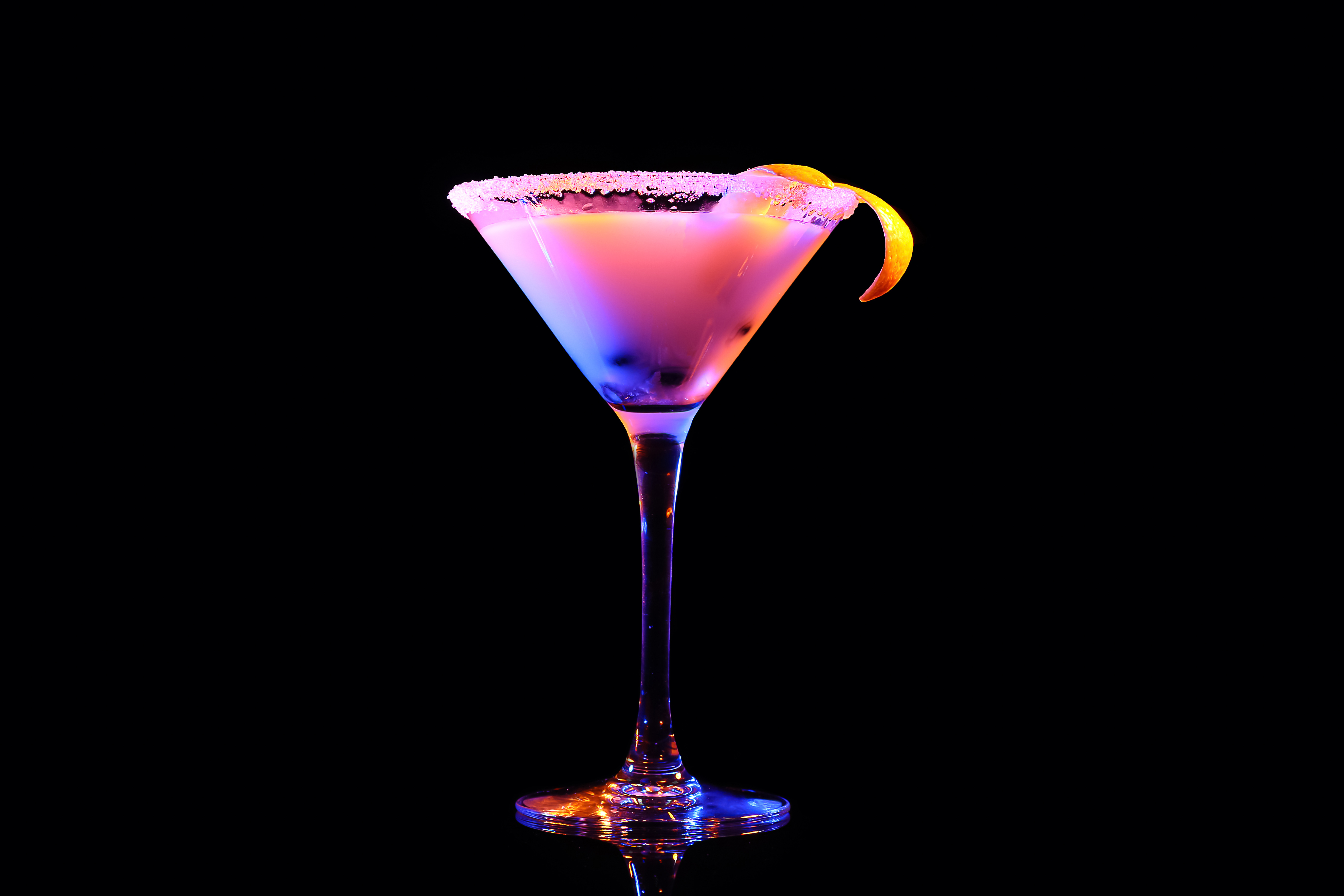 A cocktail in a glass on a dark background