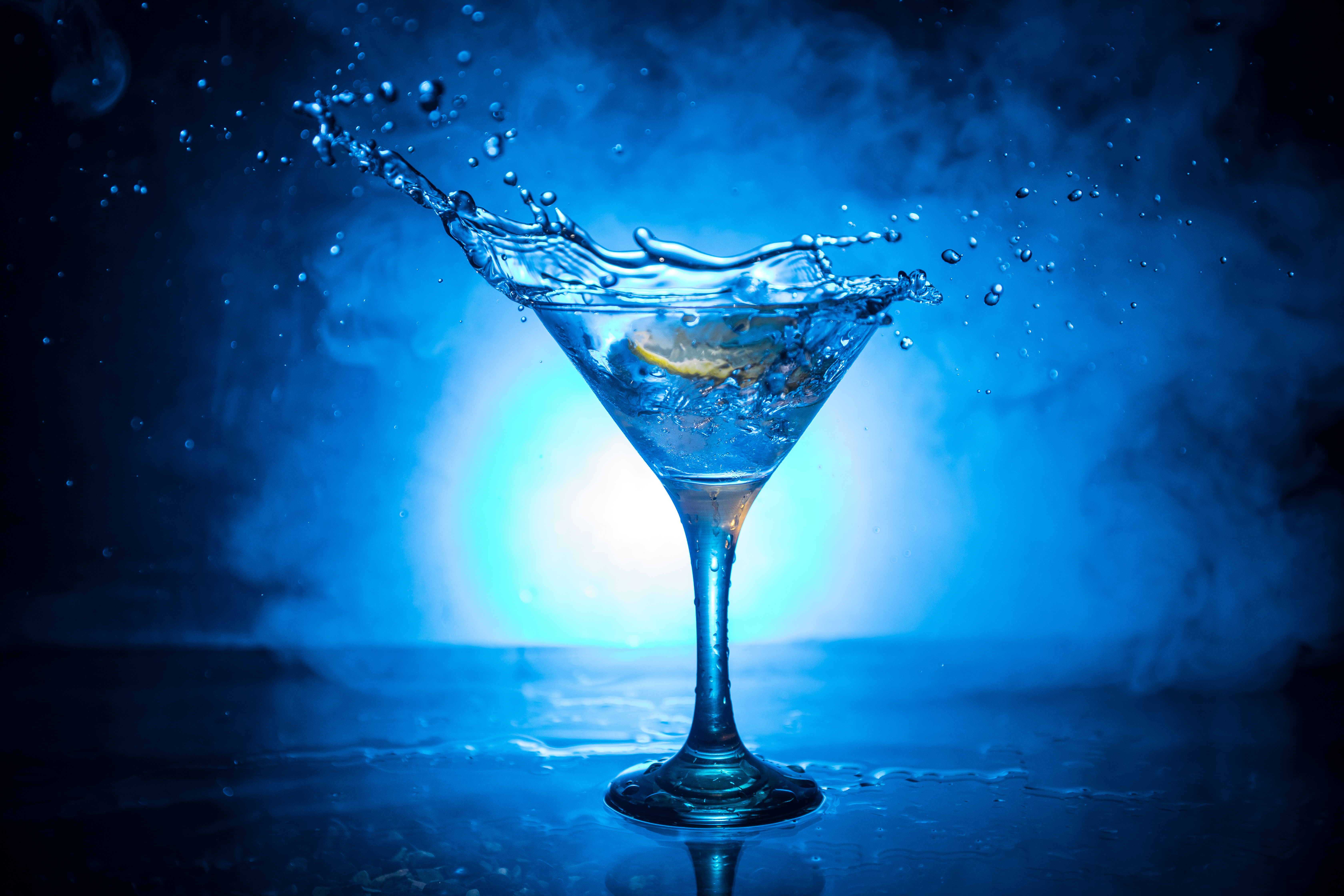 A martini cocktail on a dark smoky background
