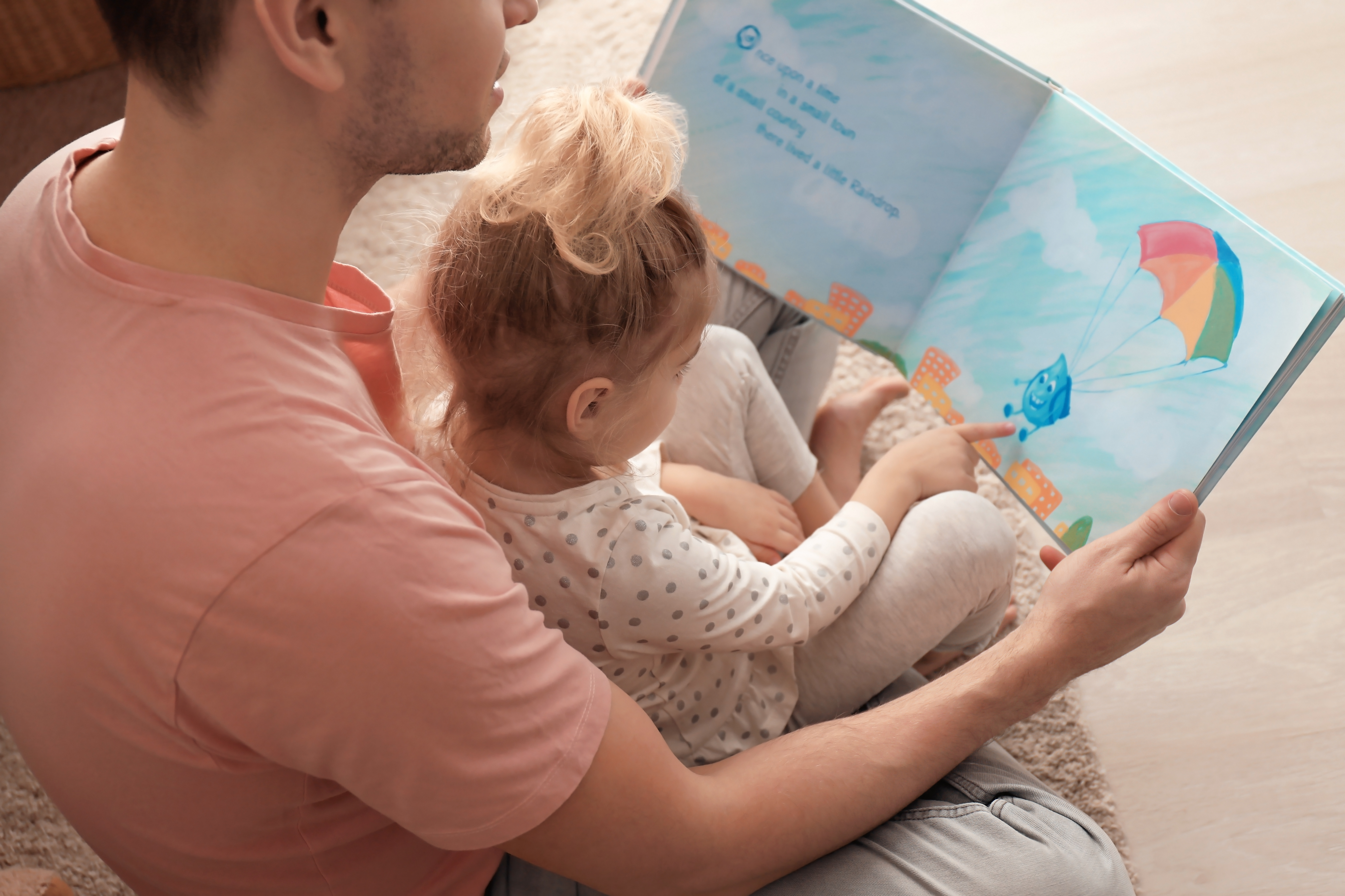 Two people reading a book together